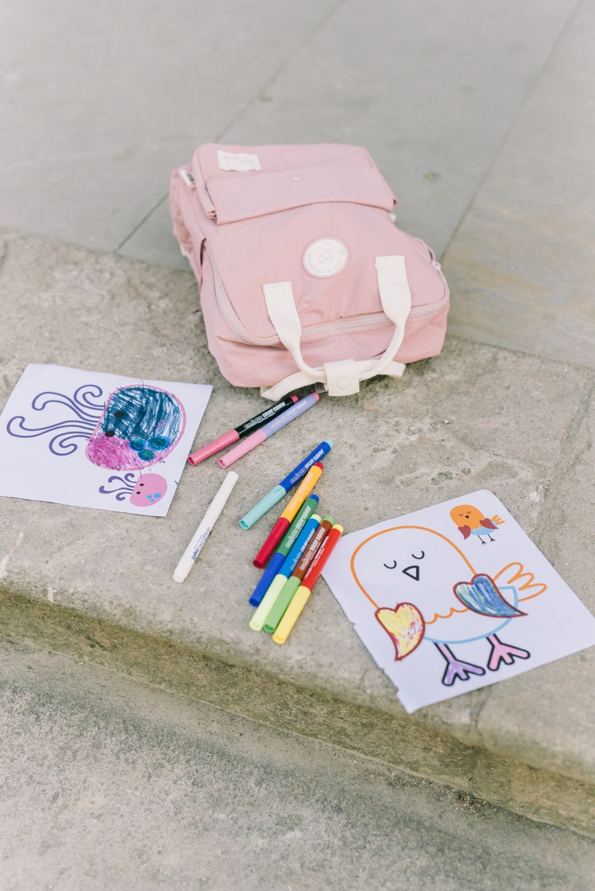 coloring materials and a pink backpack